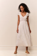 White midi dress with V-neck and cap sleeves, featuring embroidered yoke and panel tiers