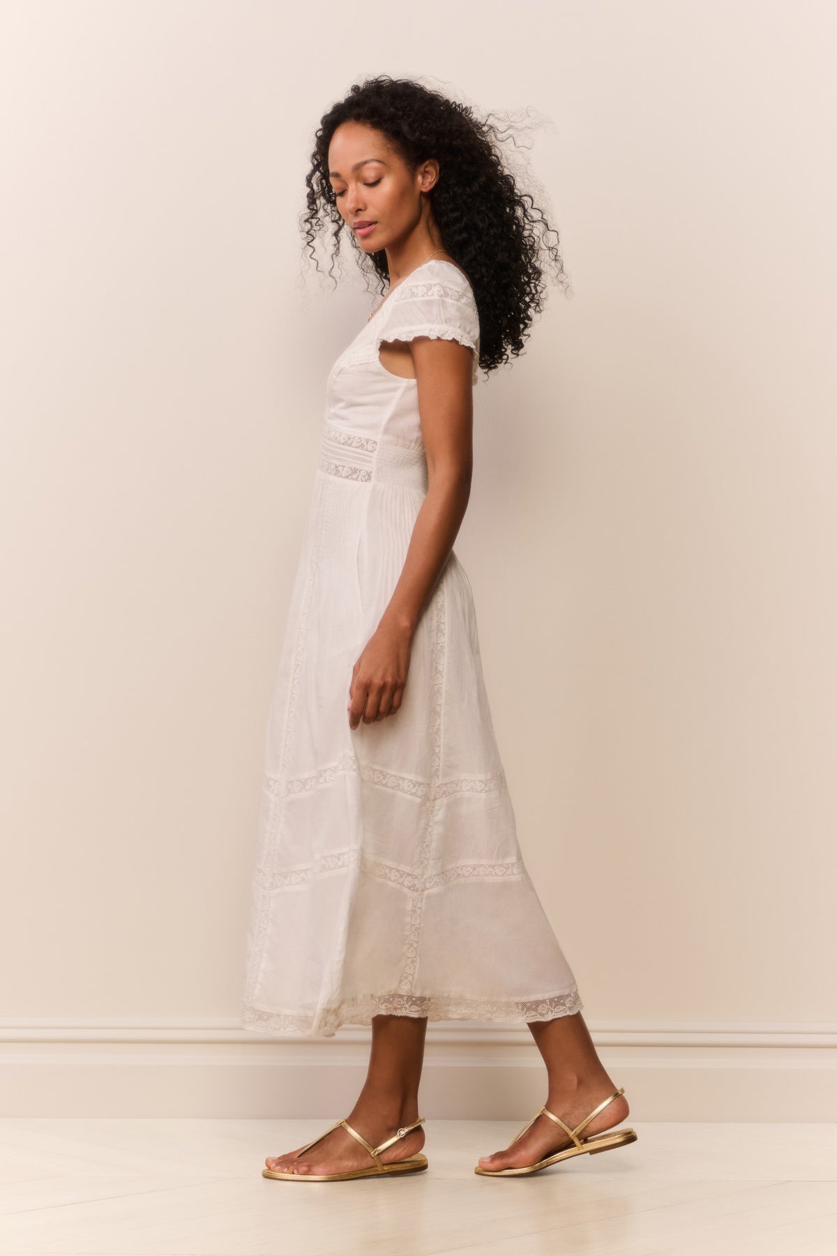 White midi dress side view with V-neck, cap sleeves, and embroidered tiered panels