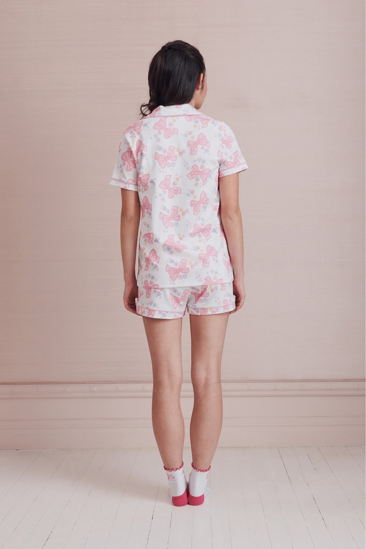 Women’s light pink bow print pajama set, polo top and matching shorts from back