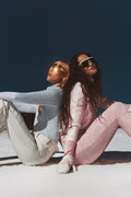 Light pink patterned ski pants shown in full length on a model