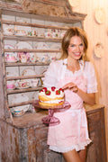 Perennial pink printed apron with white lace-trim pockets and neck ties