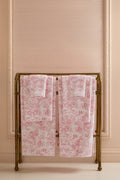 Pair of pink cotton hand towels with all-over floral print, folded