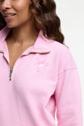 Pink half-zip sweatshirt with embroidered character on chest and zip placket