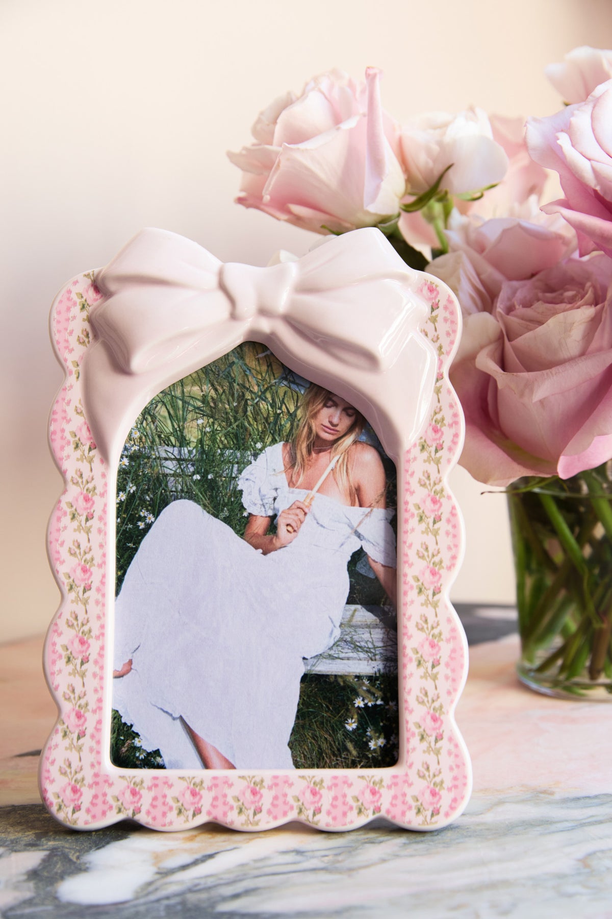 Pink floral decorative photo frame with large satin bow and scalloped border