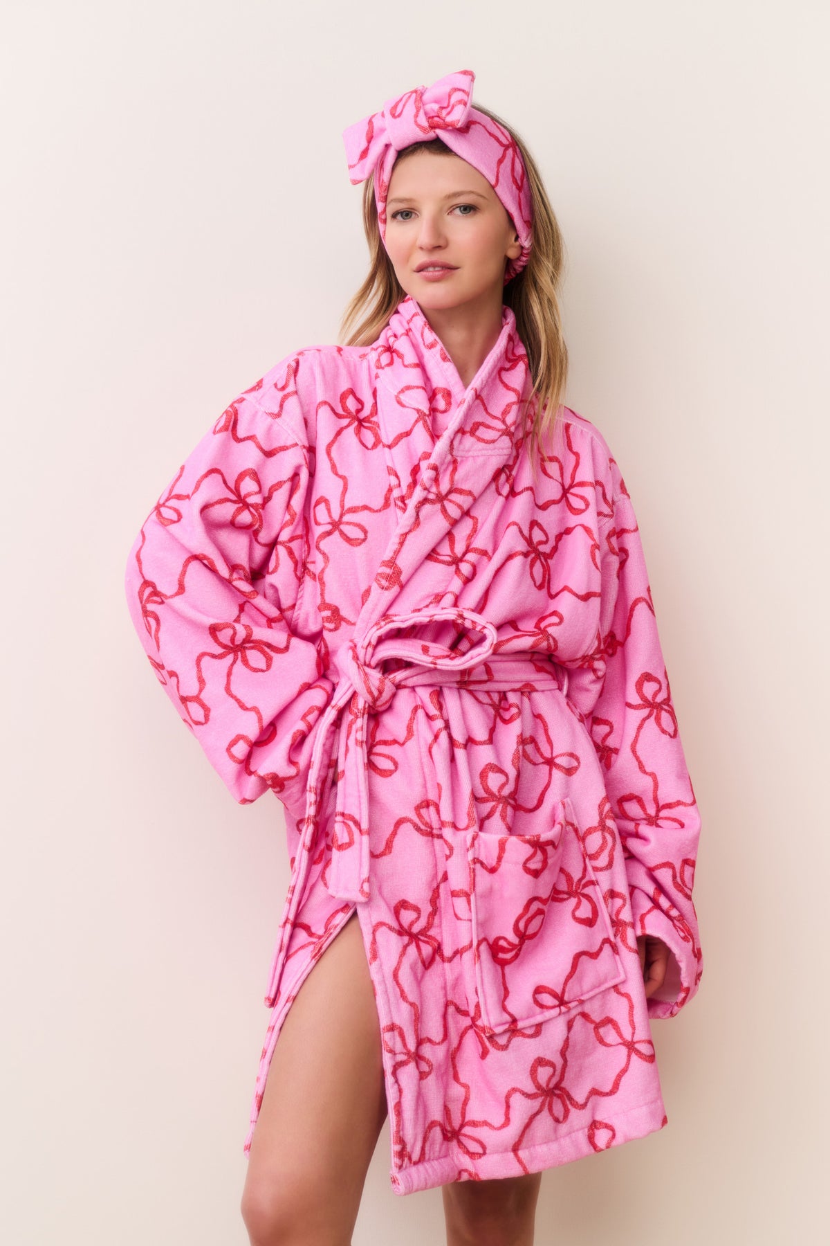 Pink cotton bath robe with bow print, tie belt and hood with knotted bow