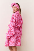 Pink cotton bath robe with bow print, hood and waist tie belt, side view