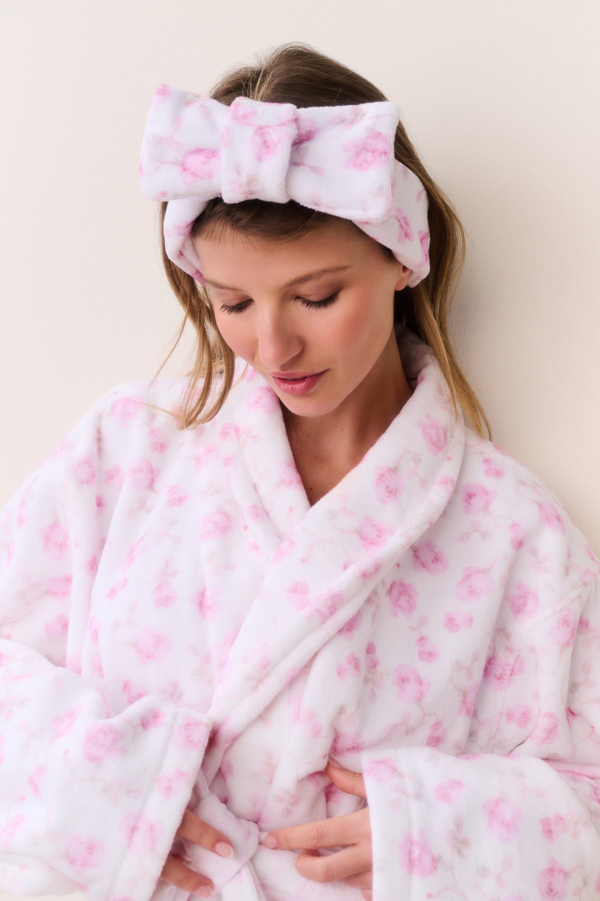 Pink floral bow headband worn on top of hair, gathered ruffle and bow knot