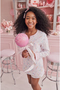 Girls' long-sleeve pajama shirt and shorts with pastel heart print, smiling