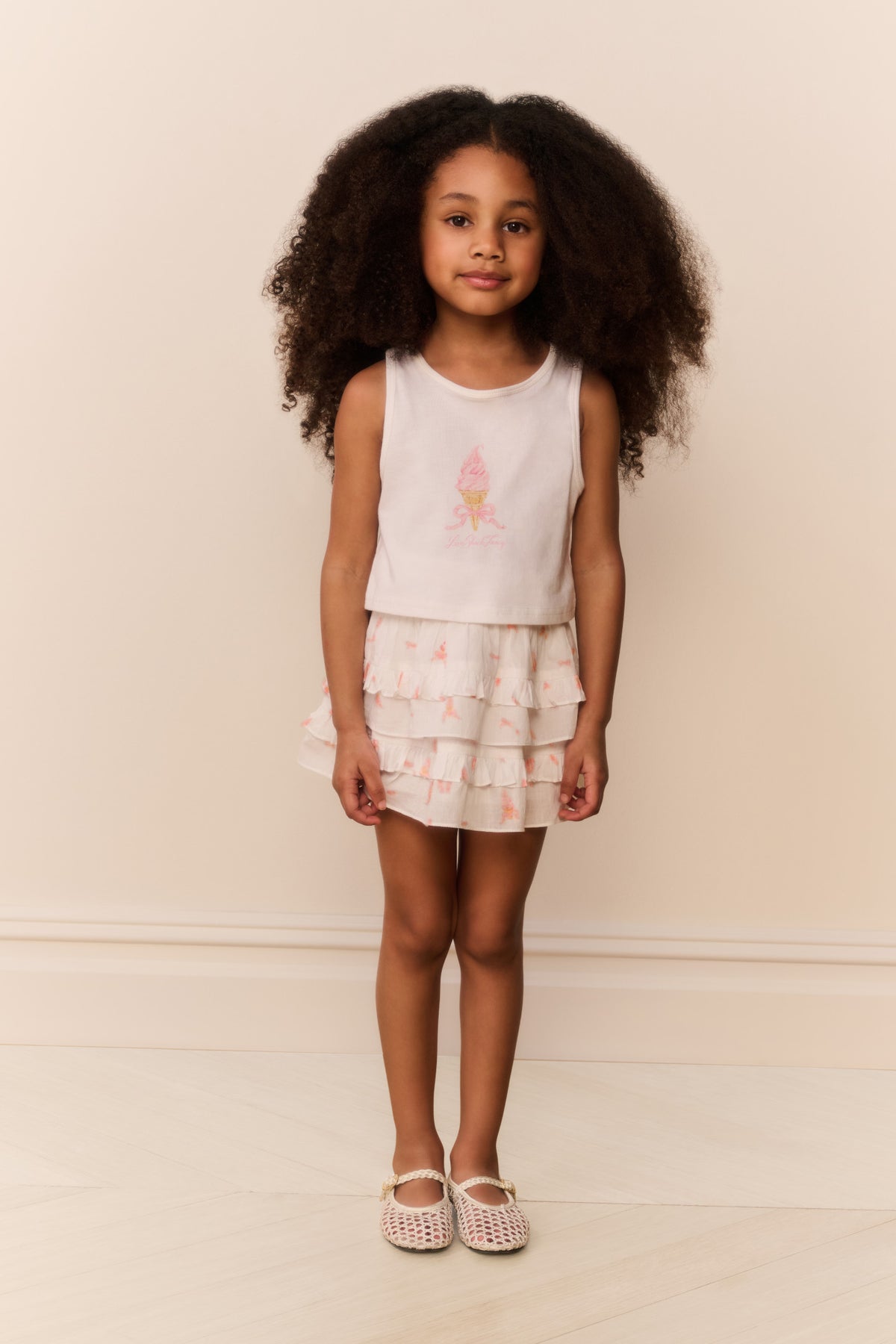 Girls pink tiered ruffle skirt with bow print, flared twirl style