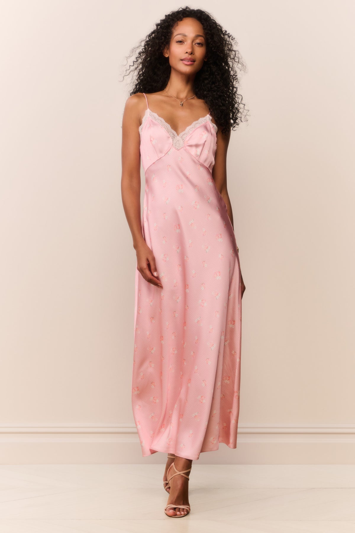 Pink maxi slip dress with lace-trim V neckline, spaghetti straps, and tiny print.