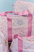 Floral duffel weekender bag with pink handles and heart logo patch, front opening