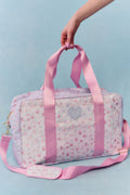 Floral duffel weekender bag with pink handles and heart logo patch, side zipper pocket