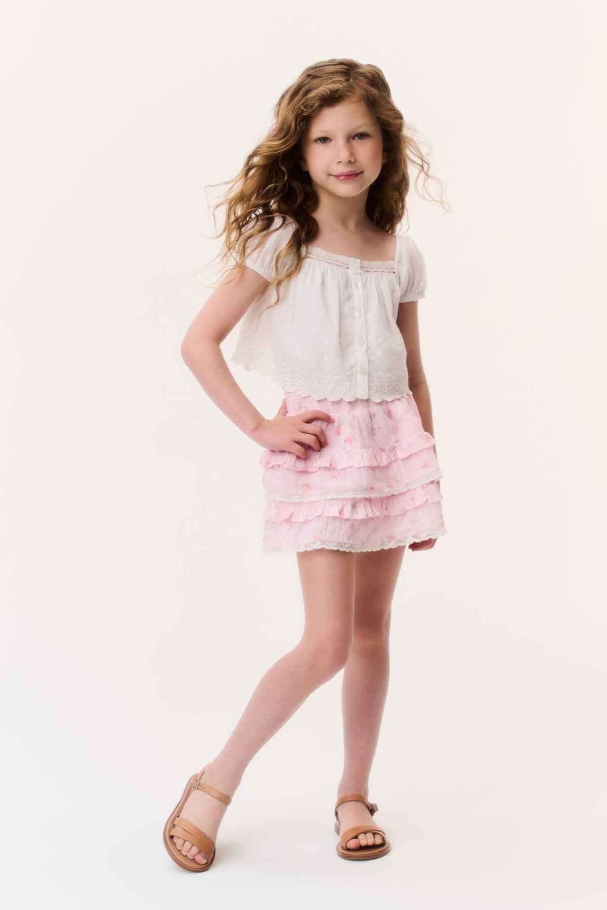 Girls light pink tiered ruffle mini skirt, front view