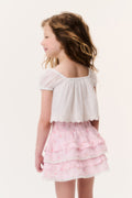 Girls light pink tiered ruffle mini skirt, back view
