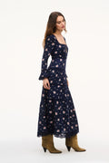 Navy floral maxi dress side view with long sleeves and tiered skirt