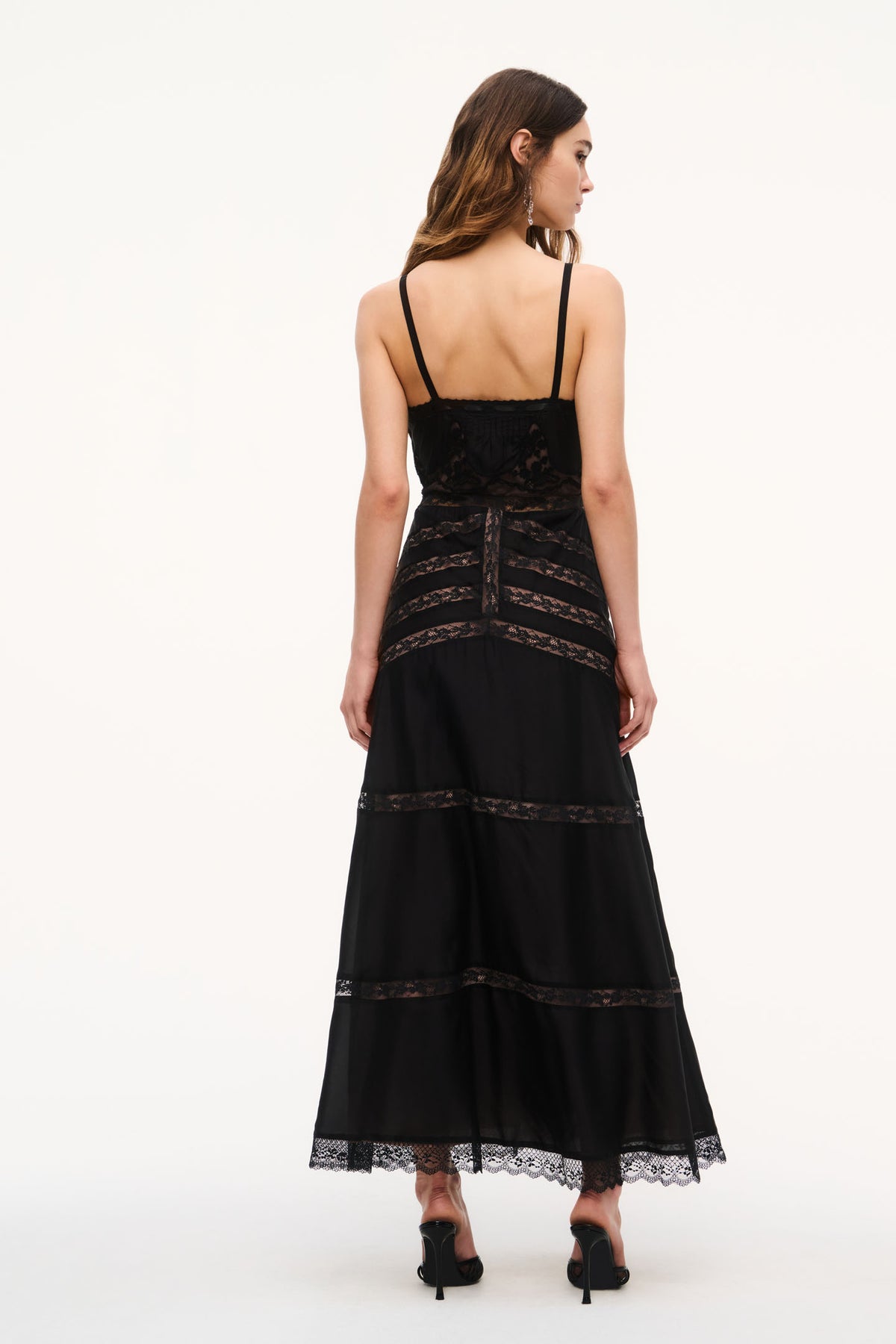 Black lace maxi dress with spaghetti straps and tiered lace hem (back view)