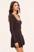 Dark brown pointelle mini dress with long sleeves and tiered ruffle skirt, side view.