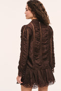 Dark brown silk lace blouse back view with ruffled texture and lace hem