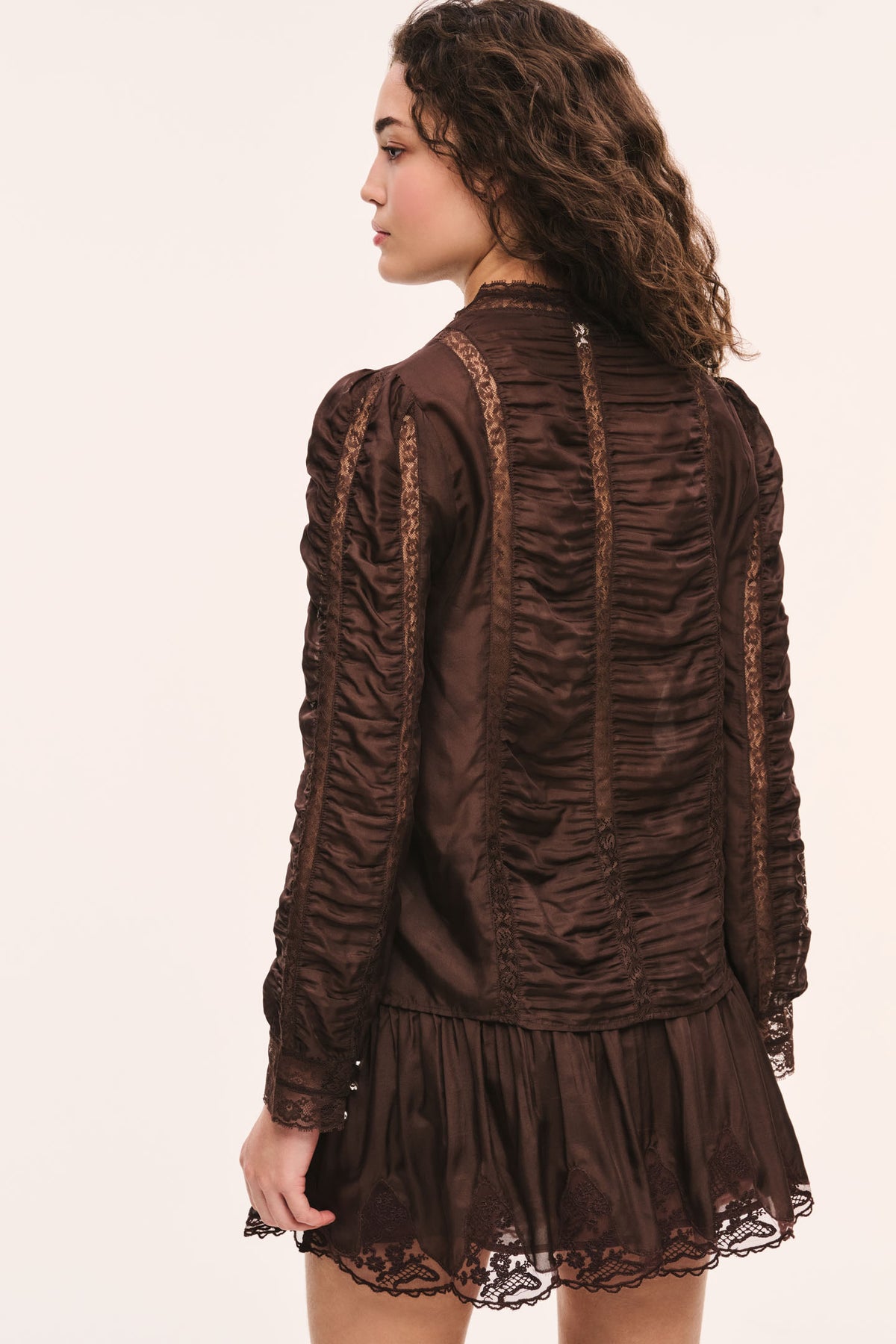 Dark brown silk lace blouse back view with ruffled texture and lace hem