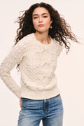 Ivory textured knit sweater with bow-like front details and crew neckline