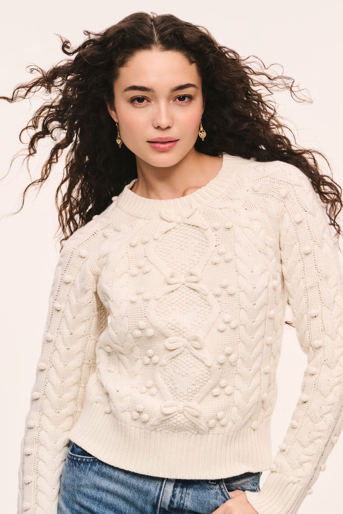 Ivory textured cable-knit sweater with crew neckline and long sleeves