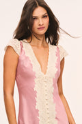 Pink satin midi dress close-up with cream lace V-neck and cap sleeves