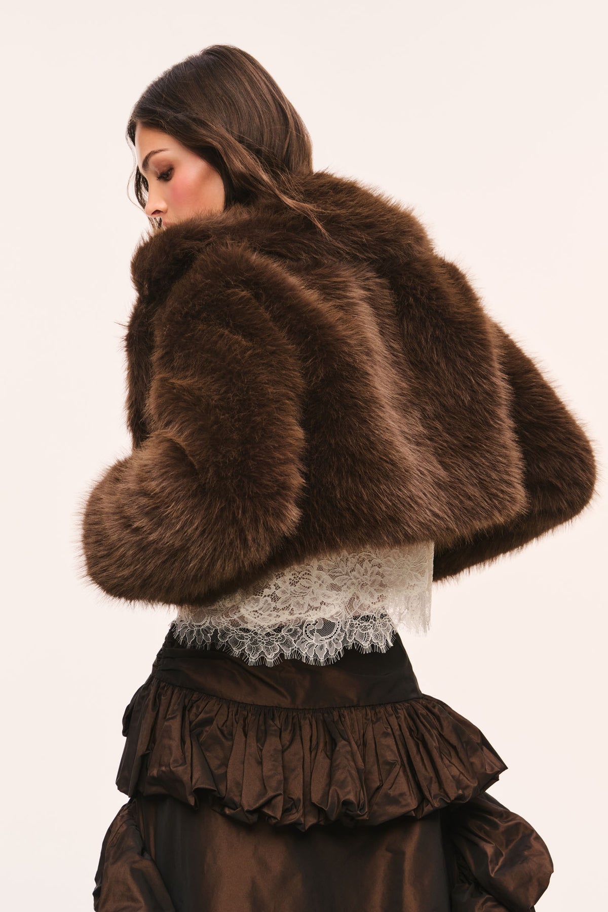 Dark brown cropped faux fur jacket with textured sleeves and high collar