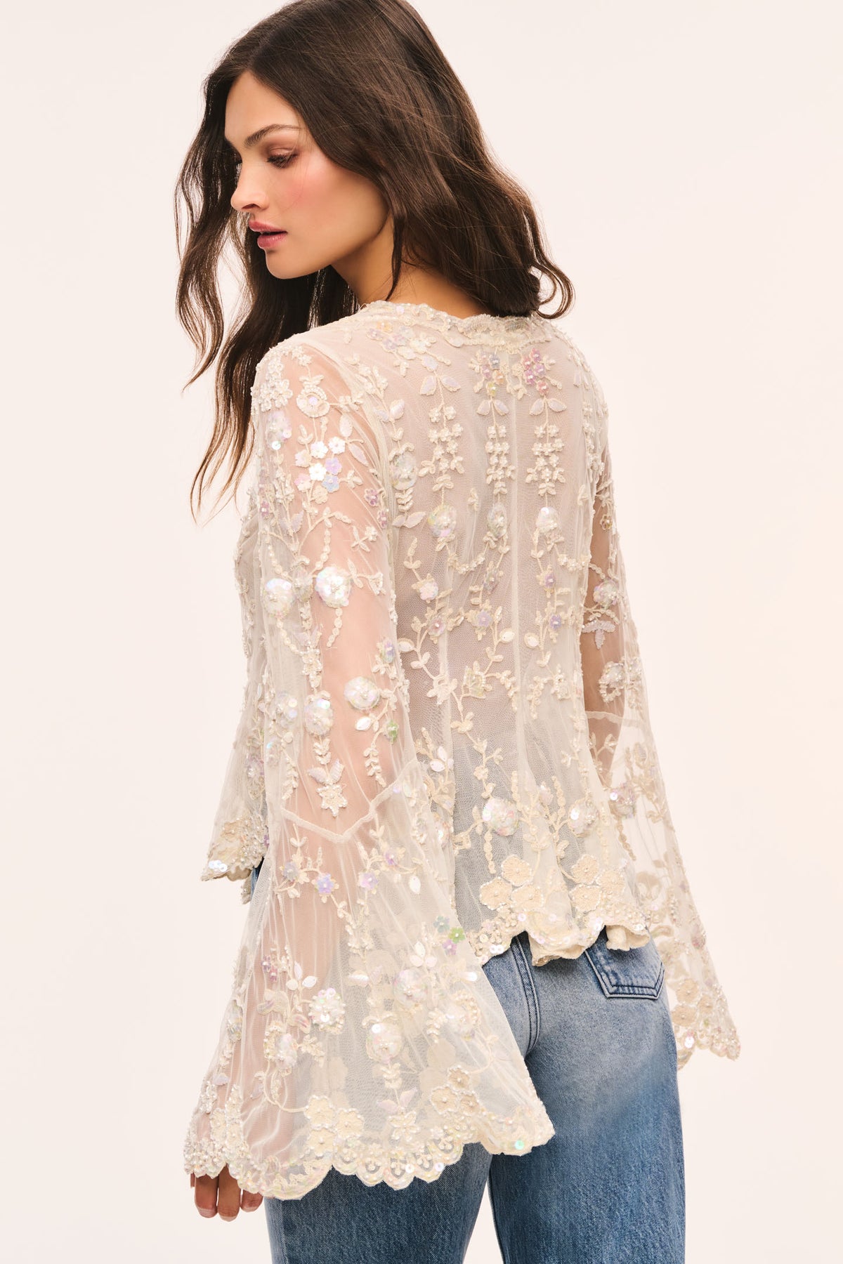 Back view of cream pearl-embroidered mesh top with long sleeves