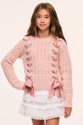 Tween pink textured knit pullover front view with ribbon threaded through and bow at hem