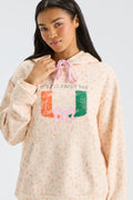 Light peach hoodie close-up with kangaroo pocket and multicolor 'LC' graphic