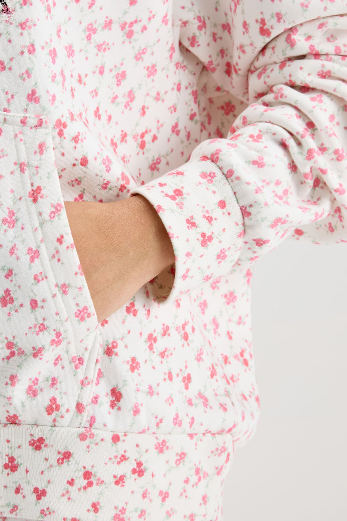 Pink floral-print hoodie sleeve with rib cuff and front pocket opening detail