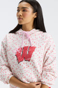 Pink patterned Nacova hoodie close-up of red W logo and drawstring hood.