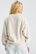 Cream mockneck crew sweatshirt, back view with small ribbon emblem