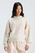 Cream mockneck sweatshirt with "LOVE" lettering detail across the chest