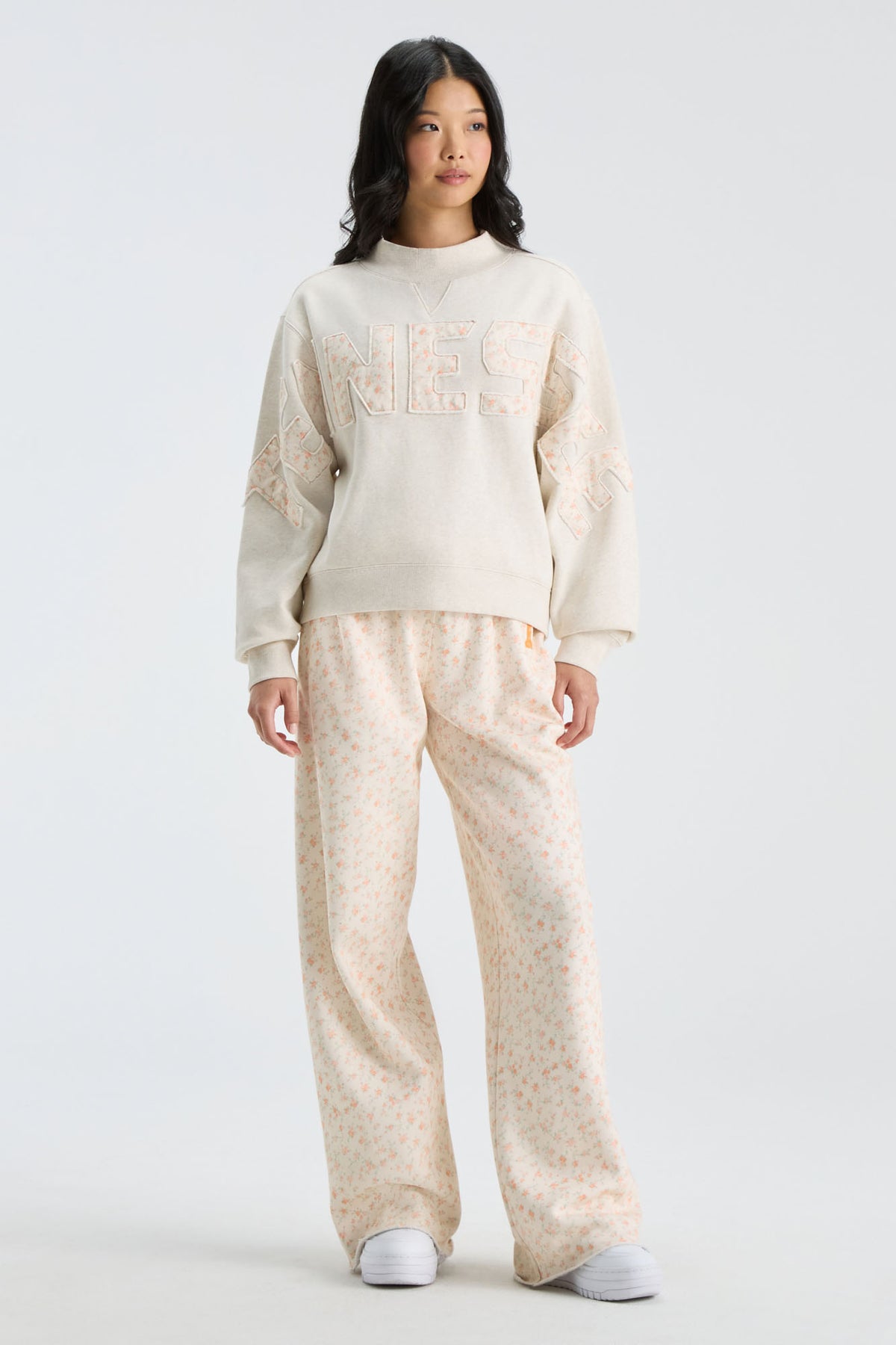 Cream mockneck sweatshirt with "LOVE" graphic and matching long-sleeve fit