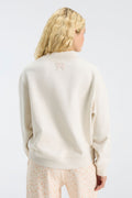 Cream mockneck sweatshirt back view with small "LOVE" emblem at center