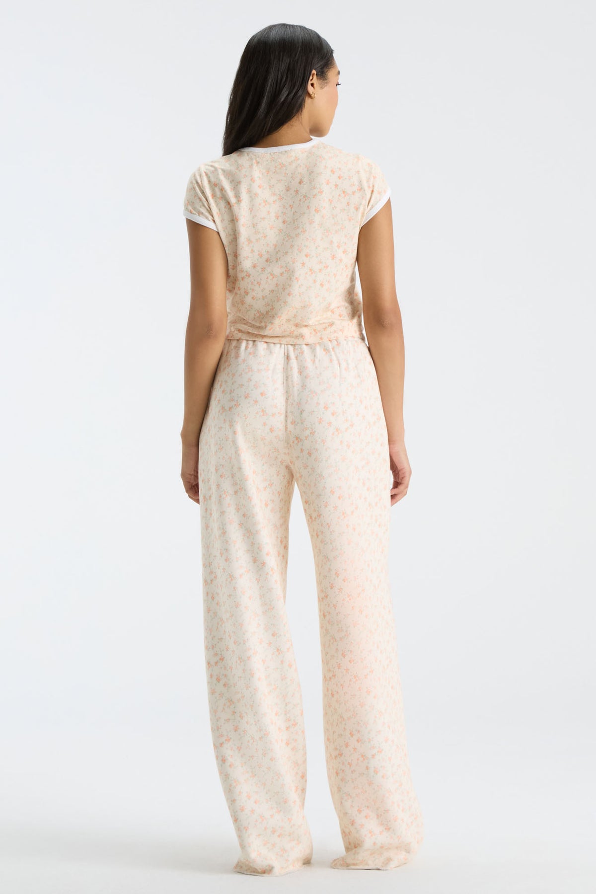 Cream floral-print sweatpants, back view with elastic waistband and wide legs