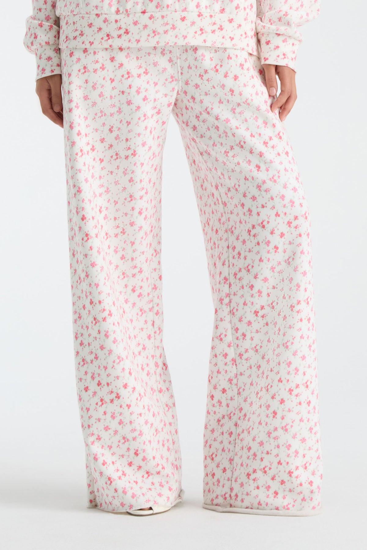 Cream floral-print wide-leg sweatpants with elastic waist and drawstring