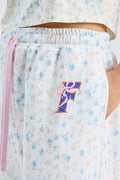 White and light-blue floral sweatpants with elastic waistband and pink drawstring cord