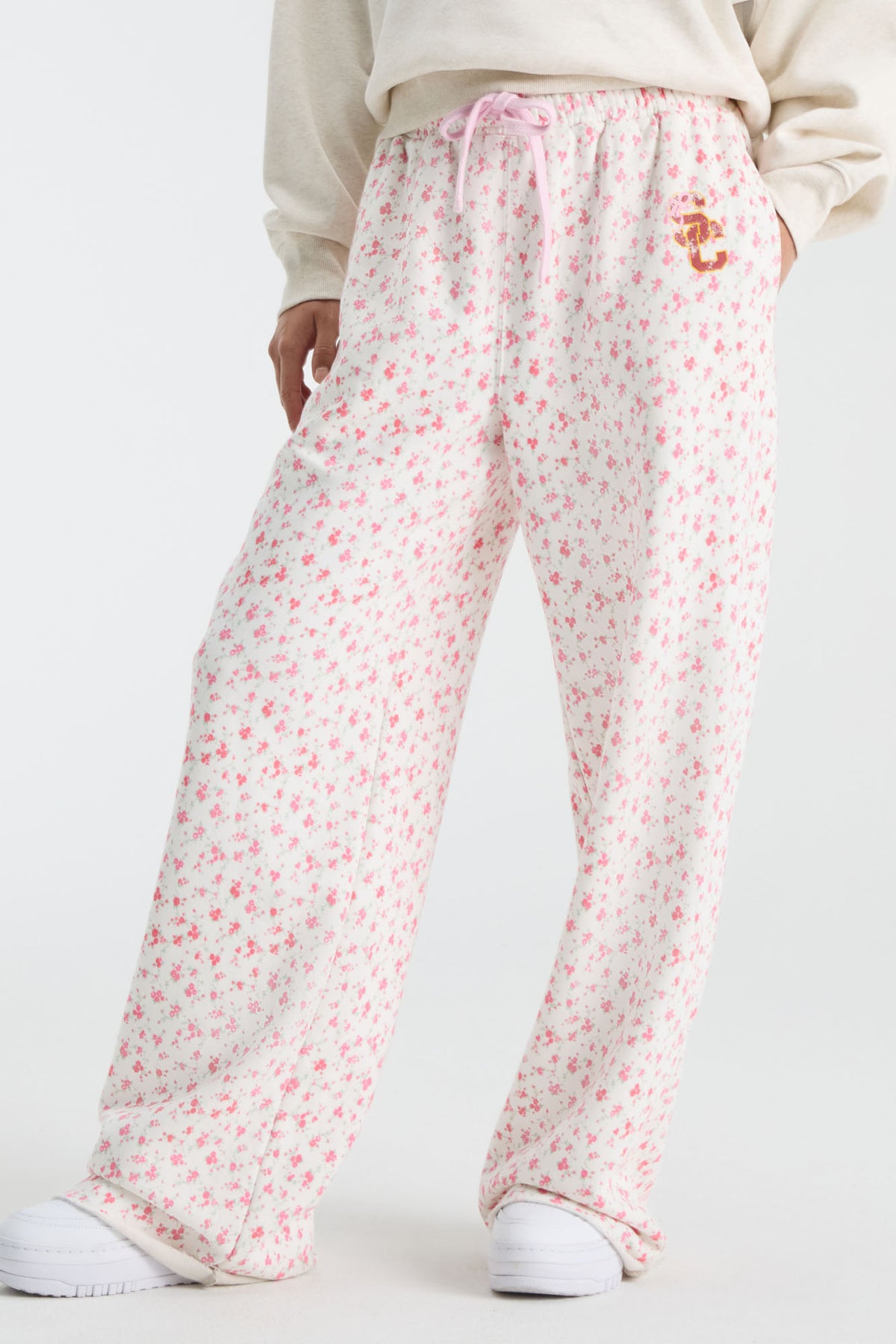 Pink ditsy floral sweatpants with elastic waist and pink drawstring, relaxed wide legs