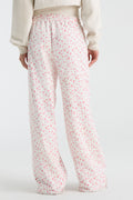 Kids pink ditsy floral sweatpants with elastic waist and relaxed wide-leg silhouette