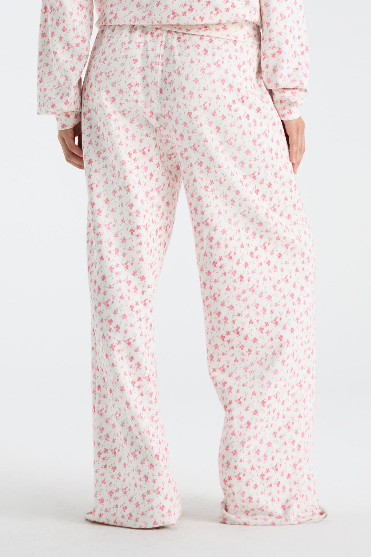 Cream floral sweatpants with elastic waist and wide straight legs