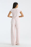 Back view of womenโs wide-leg sweatpants with elastic waistband and pale floral print
