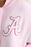 Close-up of embroidered orange letter on light pink varsity jacket sleeve front
