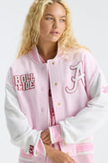 Pink varsity jacket with embroidered “Roll Tide” patch, striped ribbed cuffs, button front