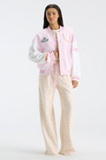 Pink collegiate varsity jacket with button front, striped cuffs, and letterman patches