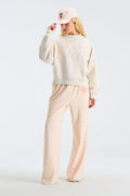 Light pink floral baseball cap worn with matching floral pajama pants