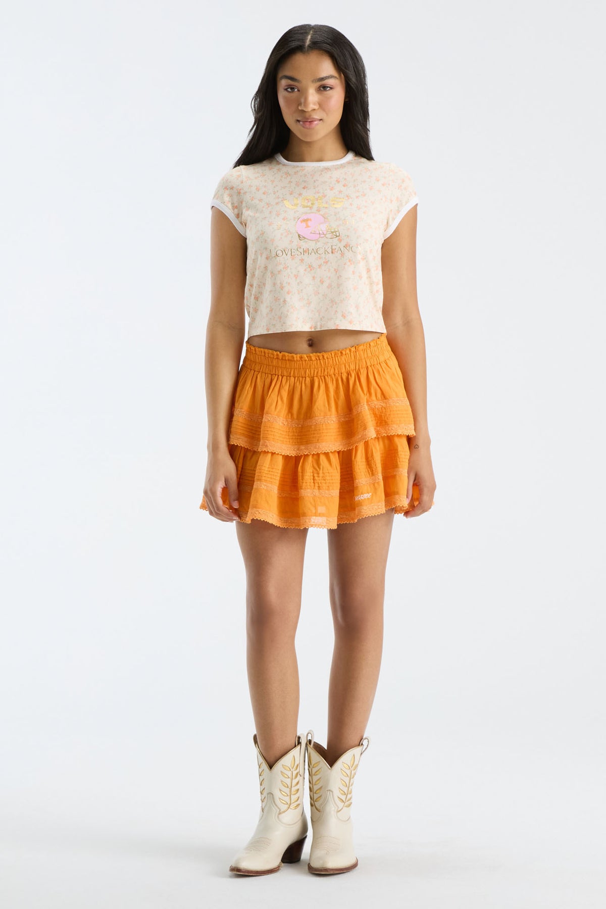 Cropped light-pink floral ringer tee with crew neck; model wears orange tiered skirt