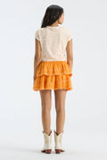 Bright orange tiered ruffle mini skirt, elastic waistband, back view