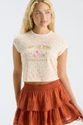 Burnt orange tiered ruffle mini skirt with elastic waistband and lace-trim edge.